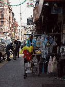 Center right photo you see gifts and New York souvenirs for sale on the sidewalk of Mulberry Street.