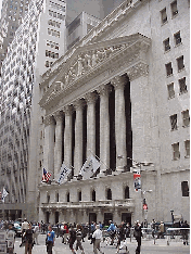 The narrow streets of downtown Manhattan are home to some of the most powerful addresses in the financial world. Top left picture you see the New York Stock Exchange on Wall Street. Here during the work week you see the traders standing outside.